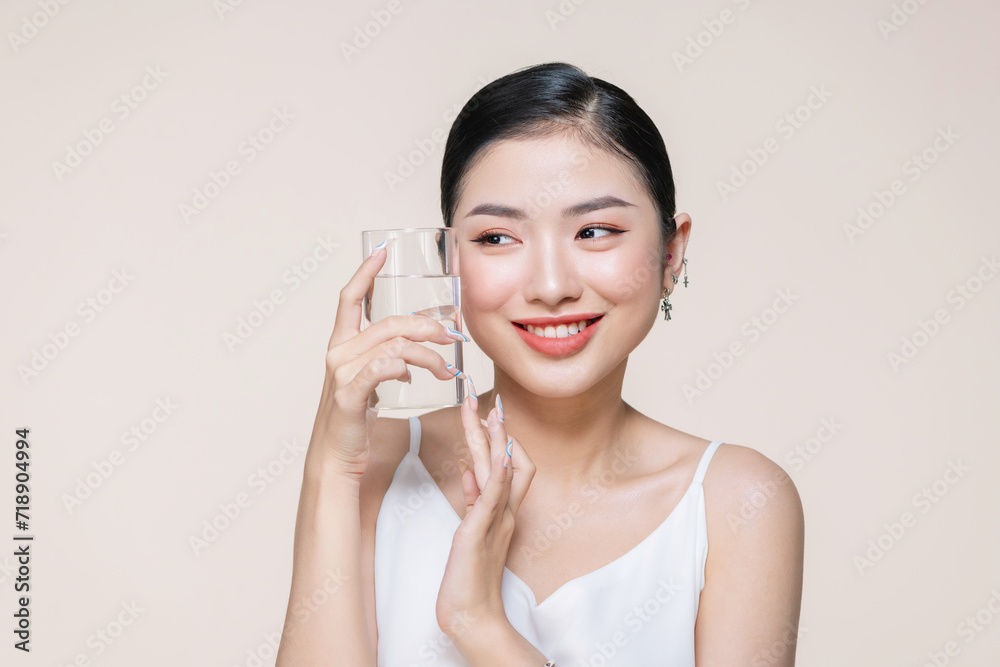 beautiful young asian woman with closed eyes holding glass of clear water near face beautiful young asian woman with closed eyes holding glass of clear water near face