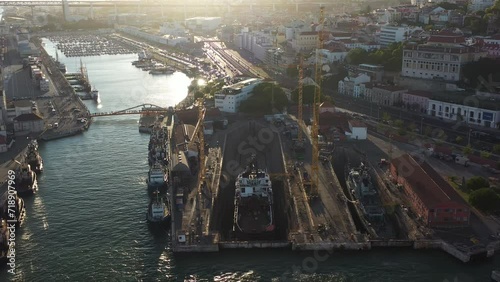 Aerial drone shot of a ship repair dry dock in Lisbon's port, situated on the north bank of the Tagus River. The shipyard is a key facility at the heart of Lisbon harbor. photo