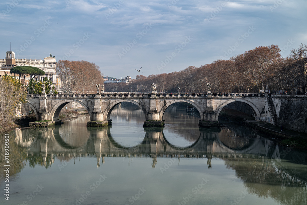 Historic Stone Bridge Over Calm Waters with Autumn Trees