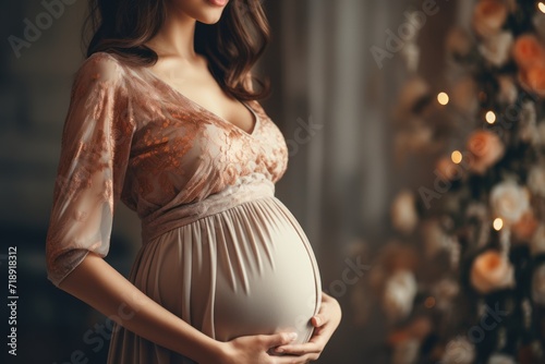 Pregnant woman in beige negligee. Pregnancy, maternity, preparation and expectation concept.