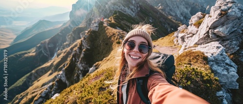 Young hiker woman taking selfie portrait on the top of beautiful mountain - Happy guy smiling at camera
