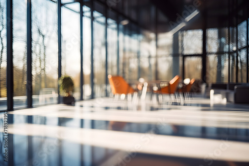 Modern glass house interior on a sunny day with a cozy workspace, featuring a chair and table for work and coffee. Beautifully blurred background showcasing panoramic windows and lovely lighting.