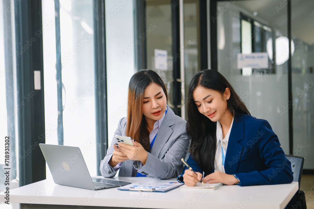 Asian business colleague business presents and explains and using laptop and tablet. Teamwork, financial marketing team, Asian business colleague business presents and explains and using laptop and tablet. Teamwork, financial marketing team,