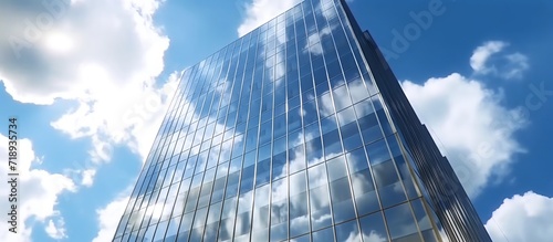 Modern office building with glass facade on a clear sky background. photo