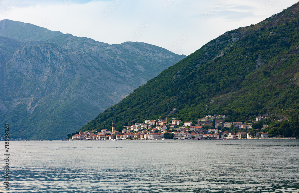 Kotor, Montenegro - 06 11 2023: View of Perast from the other side of the bay. Distant view of Church sv. Ivan and the building surrounding it