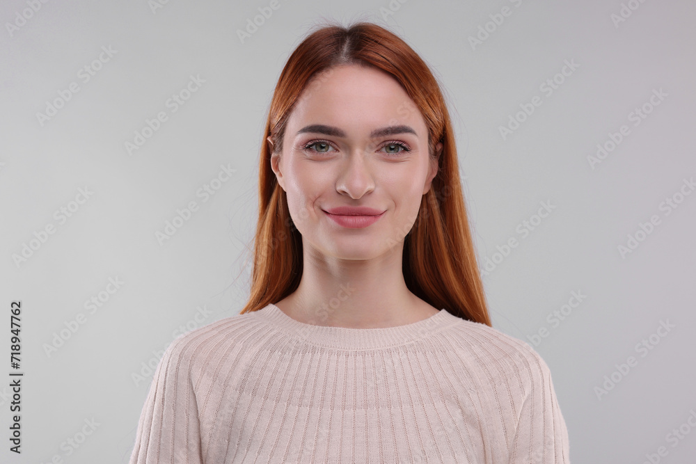 Obraz premium Portrait of happy woman on light grey background