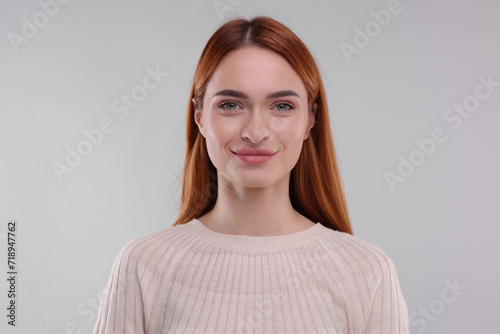 Portrait of happy woman on light grey background