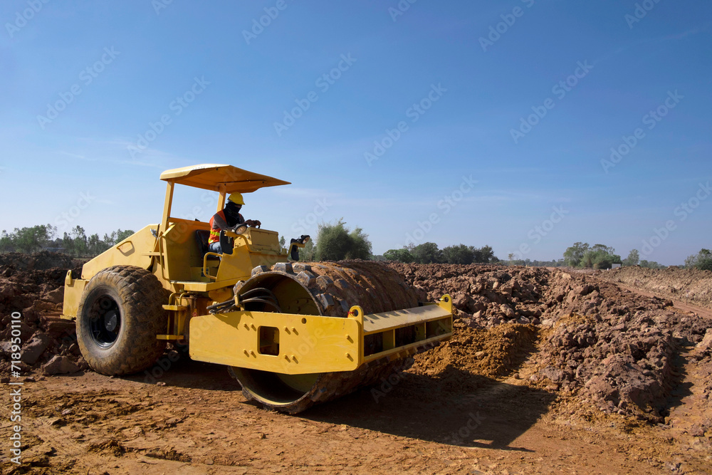 Soil compactor padfoot drum is working. Road roller during highway building