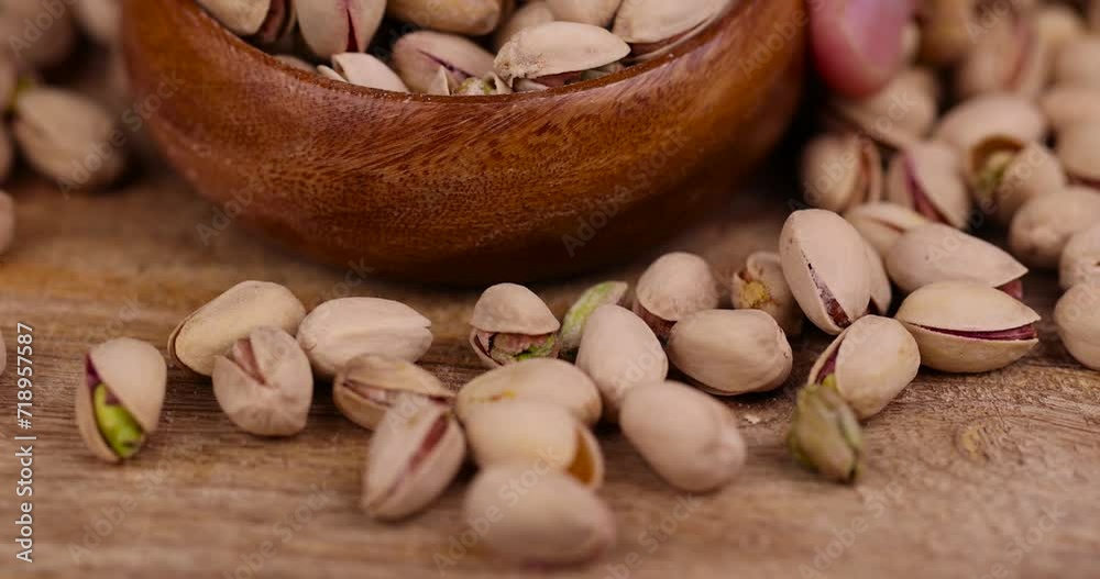 Salted fried pistachios on the table, pistachio nuts close-up