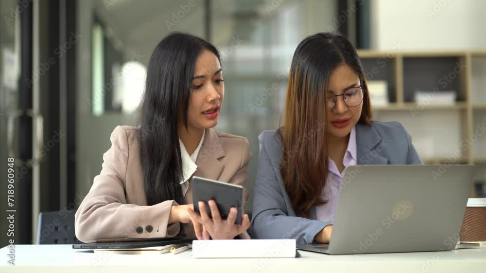 Business team using a calculator to calculate the numbers of statistic business profits growth rate on documents graph data, desk in the office. Business team using a calculator to calculate the numbers of statistic business profits growth rate on documents graph data, desk in the office.