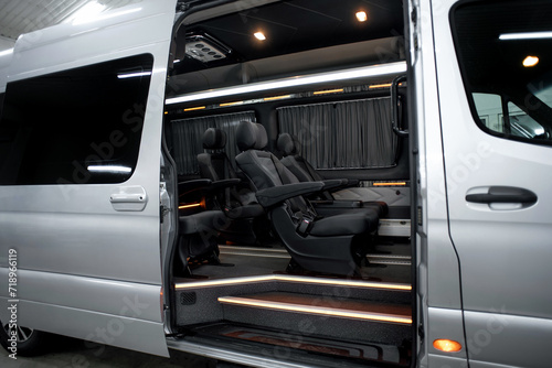 Comfortable interior of a passenger bus with soft seats. The design is made to order. Private covering of cars. Various elements of the bus interior.