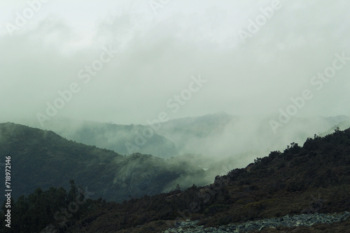 Heavy fog hangs over rugged country hills