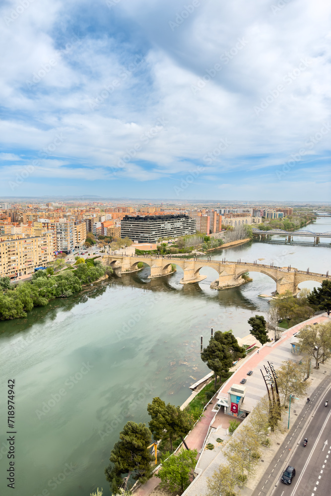Aerial view of Zaragoza cityscape and stone bridge over Ebro river from Pilar Basilica tower. Saragossa, Spain . High quality photo