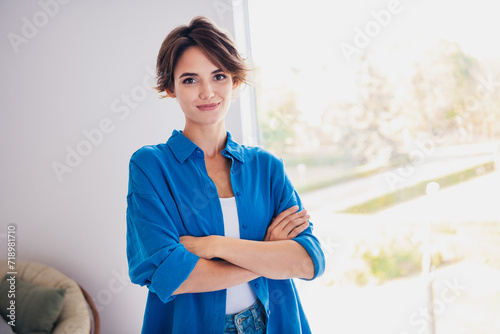 Photo of confident successful woman realtor standing in room showing modern flat photo
