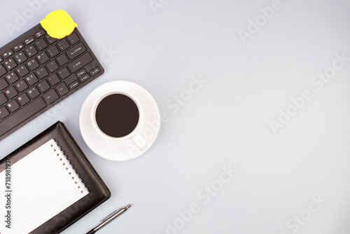 Tablet, calculator, phone, pen and a cup of coffee, lot of things on a light background. Top view with copy space.