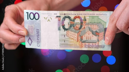 close-up Belarusian 100 hundred ruble bill in female hands photo
