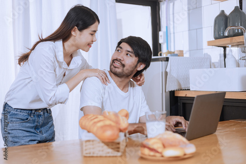 Happy two asian businesswoman working with laptop at home, 