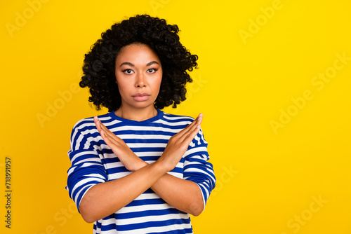 Photo of confident serious woman wear stylish clothes showing two crossed arms empty space isolated on yellow color background © deagreez