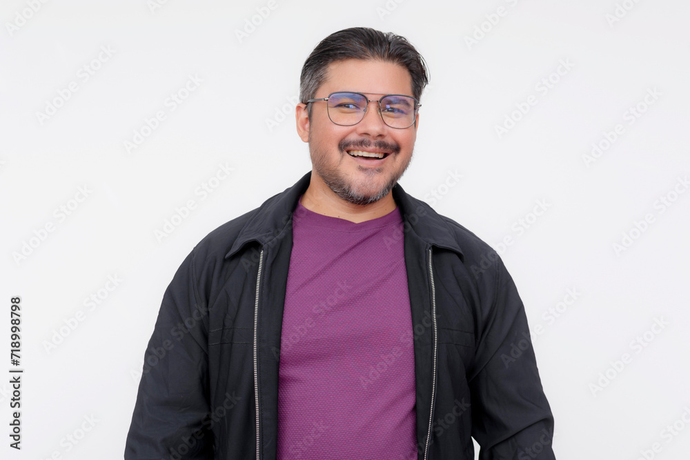 Portrait of a cheerful middle-aged man wearing glasses, a purple shirt, and casual black jacket, isolated on white. Portrait of a cheerful middle-aged man wearing glasses, a purple shirt, and casual black jacket, isolated on white.