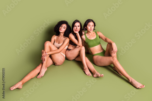 Full length studio top view photo of adorable shiny women wear lingerie embracing accepting unperfect skin isolated pastel khaki color background