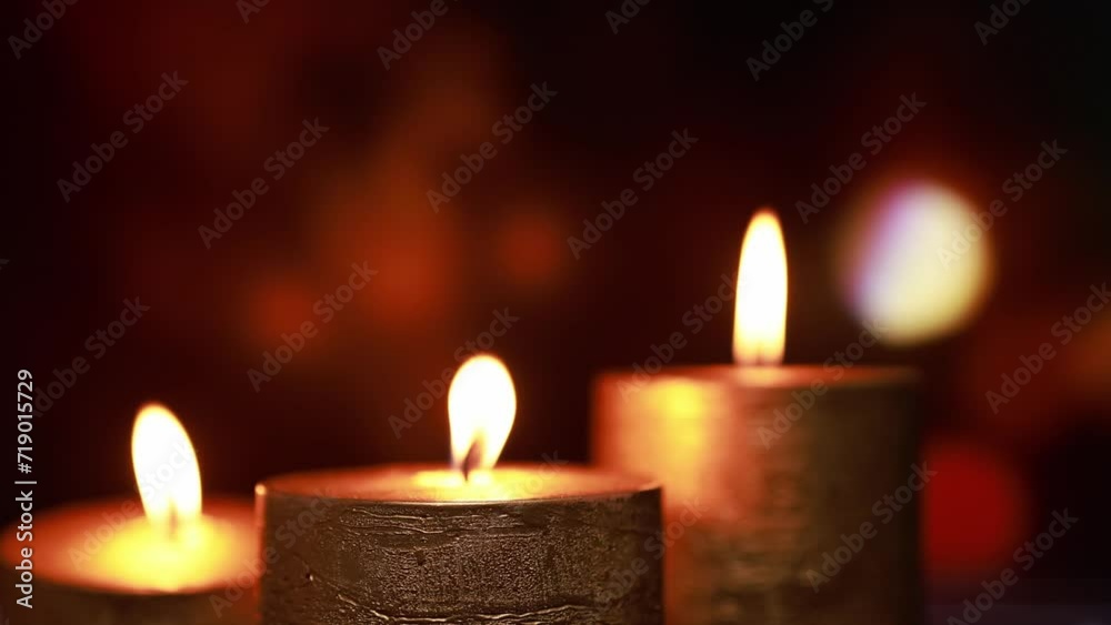 Golden thick candles on a background with bokeh. Golden thick candles on a background with bokeh.