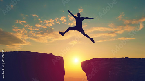 Silhouette of Enthusiastic man jumping between two cliffs. Success and freedom concept