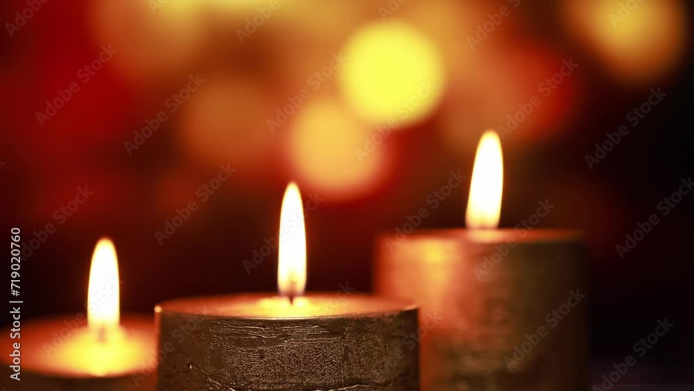 Golden thick candles on a background with bokeh. Golden thick candles on a background with bokeh.