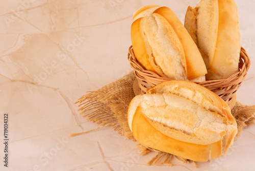 Fresh baked flour bread in stone marmorized clean background in aerial top view angle with empty blank space photo