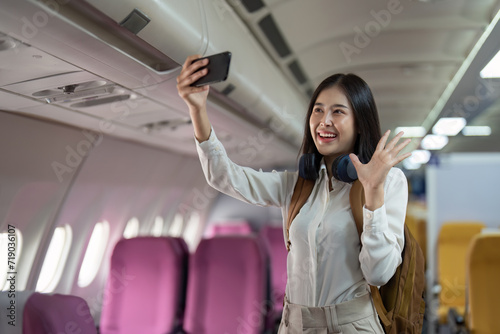 Alone Asian woman passenger traveling by plane. happy traveler on board. Solo travel concept