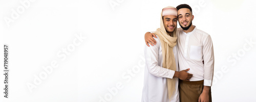 Two Middle Eastern Men in White Tunics Embrace Each Other  Fictional Character Created By Generative AI. 