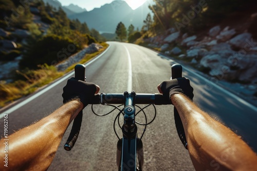 Photo of a cyclist in sporty attire, close-up on hands gripping handlebars, scenic mountain road in the 