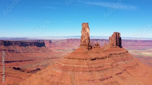 Drone makes flyby high orange rocks tower remains formation of canyon in Castle Valley Utah Usa. Fantastic ancient landscape of desert nature and sandstone erosion. Aerial view foothills massive