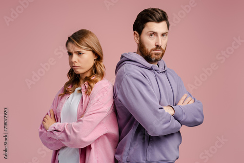 Portrait of offended couple standing and feeling sad with crossed arms  photo