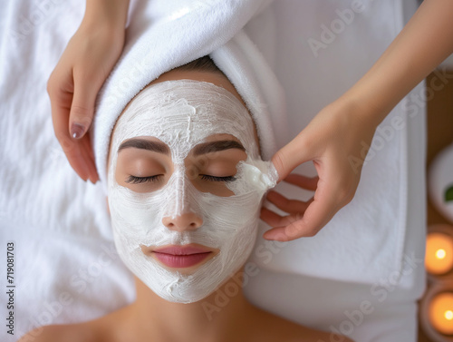 Woman enjoying a relaxing spa treatment with a face mask in a beauty salon
