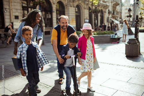 Happy diverse family walking together in urban setting