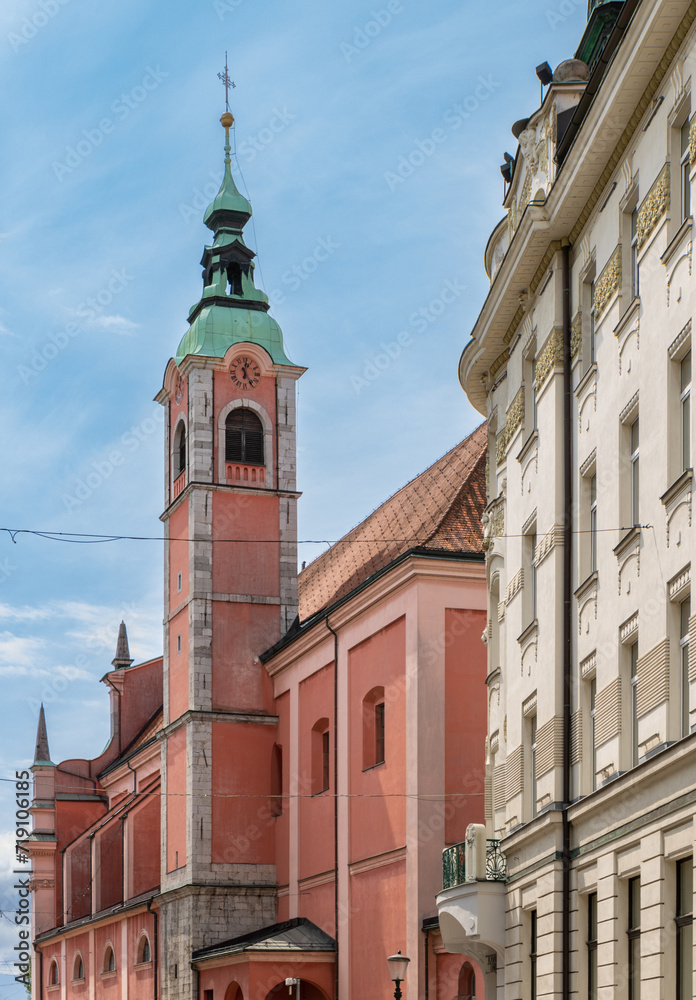 Fototapeta premium Franciscan Church of the Annunciation (Frančiškanska cerkev Marijinega oznanjenja) from the historic center street Miklošičeva Cesta towards Prešernov Trg square, Ljubljana, Slovenia