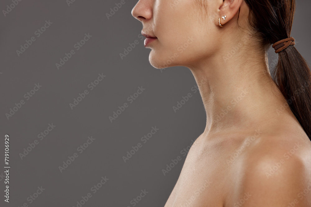 Double chin. Cropped image of female face, profile against studio background. Face lifting, massage, plastic surgery. Concept of natural beauty, cosmetology and cosmetics, skin care Double chin. Cropped image of female face, profile against studio background. Face lifting, massage, plastic surgery. Concept of natural beauty, cosmetology and cosmetics, skin care