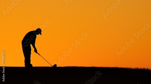 Silhouette of a professional golf playing at golf field on sunset time. © ETAJOE