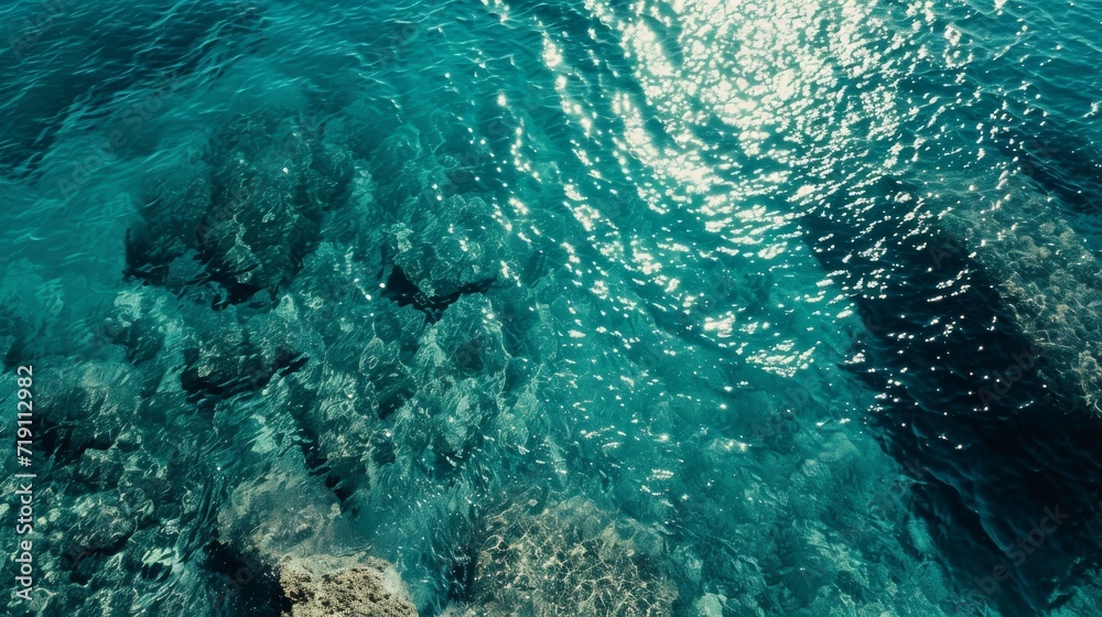 A serene aqua paradise, with turquoise and teal waters surrounded by a rocky reef, inviting for swimming and diving into the fluid marine biology of the outdoor ocean world