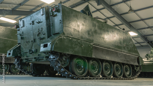 An armored personnel carrier. The rear ramp of the armored personnel carrier for boarding and unloading troops. An old tracked tank. Outdated armament of the army.