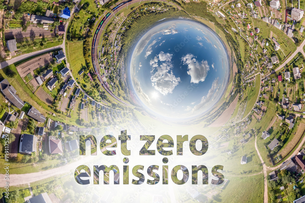 net zero emissions text concept image against blue little planet in green grass background