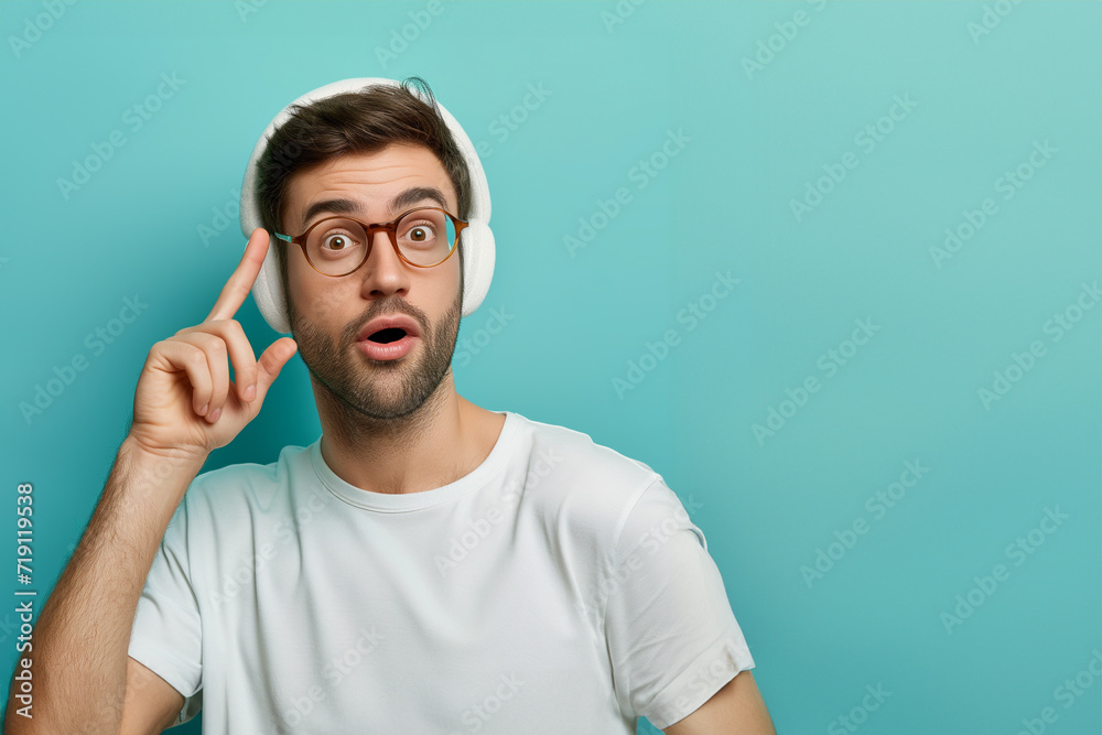 young shocked man with opened eyes and mouth putting his hands on head, isolated on a blue background. concerned young student man in casual clothes. Emotional student. young shocked man with opened eyes and mouth putting his hands on head, isolated on a blue background. concerned young student man in casual clothes. Emotional student.
