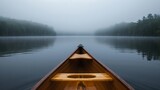 Bow of a canoe in the morning on a misty lake in Ontario, Canada.   