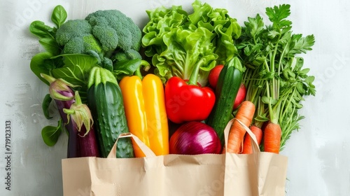 Fresh vegetables in paper shopping bag on white background  