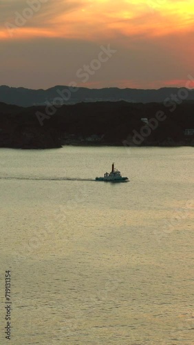 Ship navigating the bay at dusk photo