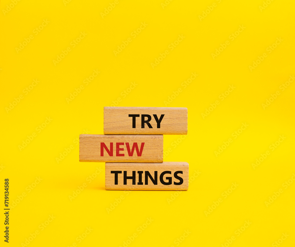 Try new Things symbol. Concept words Try new Things on wooden blocks. Beautiful yellow background. Business and Try new Things concept. Copy space. Try new Things symbol. Concept words Try new Things on wooden blocks. Beautiful yellow background. Business and Try new Things concept. Copy space.