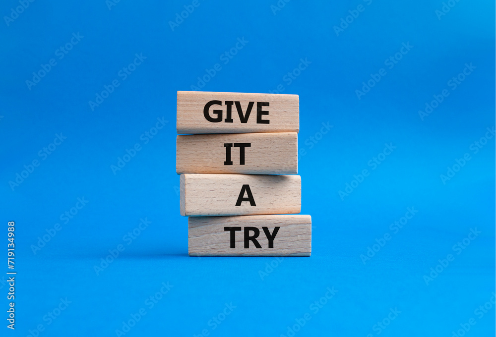 Give it a try symbol. Concept words Give it a try on wooden blocks. Beautiful blue background. Business and Give it a try concept. Copy space. Give it a try symbol. Concept words Give it a try on wooden blocks. Beautiful blue background. Business and Give it a try concept. Copy space.