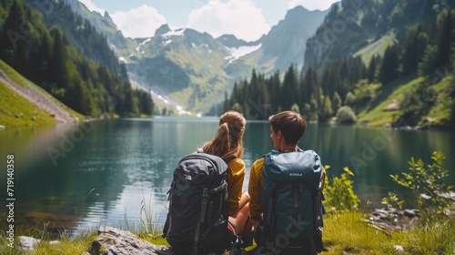 Travelers couple look at the mountain lake with backpacks . Travel and active life concept with team. Adventure and travel in the mountains region with beautiful nature