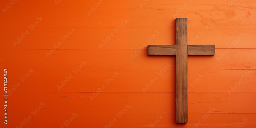 a cross on an orange wall.  the concept of Christianity as the most widespread religion in the world