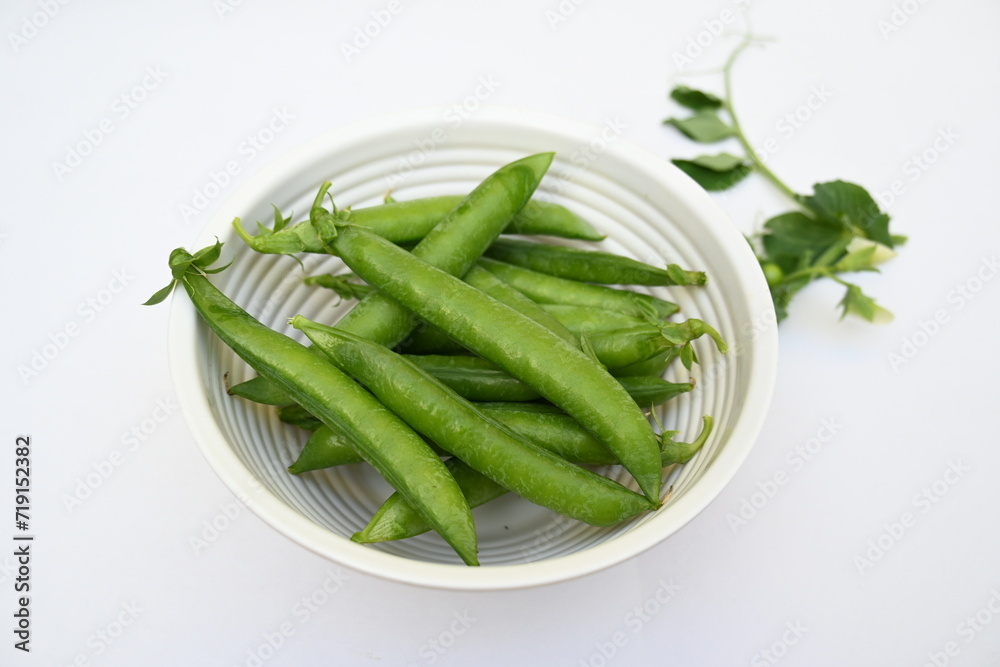 Fresh green pea isolated on white background. There is a lot of vitamins and Minerals in it. The pea is most commonly the small spherical seed or the seed. Popular vegetable of all over world. Fresh green pea isolated on white background. There is a lot of vitamins and Minerals in it. The pea is most commonly the small spherical seed or the seed. Popular vegetable of all over world.